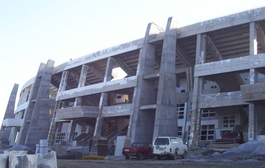The pillars that will hold one of the roofs are visible outside the stadium (October 2002)
