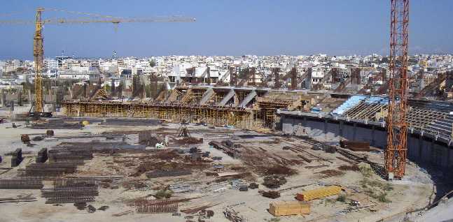 General view of the construction site from the west stand. OFI's "Theodore Vardinoyannis" Stadium can be seen in the distance (May 2002)