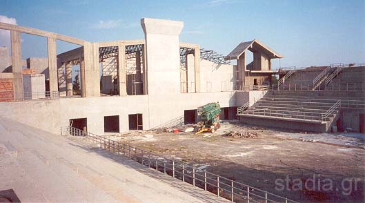 TEI Indoor Hall from the top of the smaller west stand. You may also see the metal roof of the theatre and the site of the restaurant on the left. (May 2002)